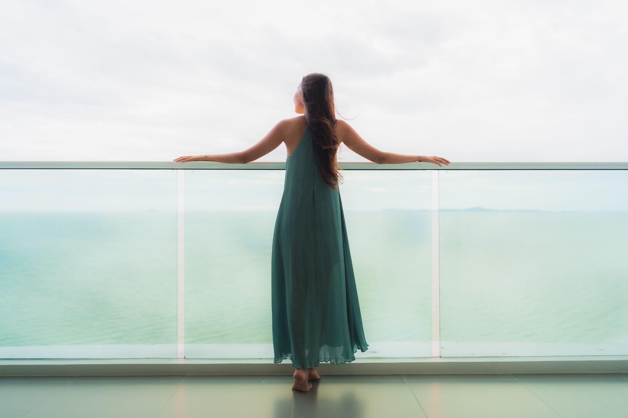 Beautiful portrait young woman happy smile relax at balcony with sea ocean